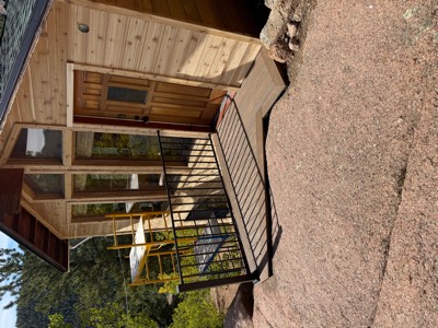 Composite entry deck and ramp built onto exposed granite at a cedar cabin